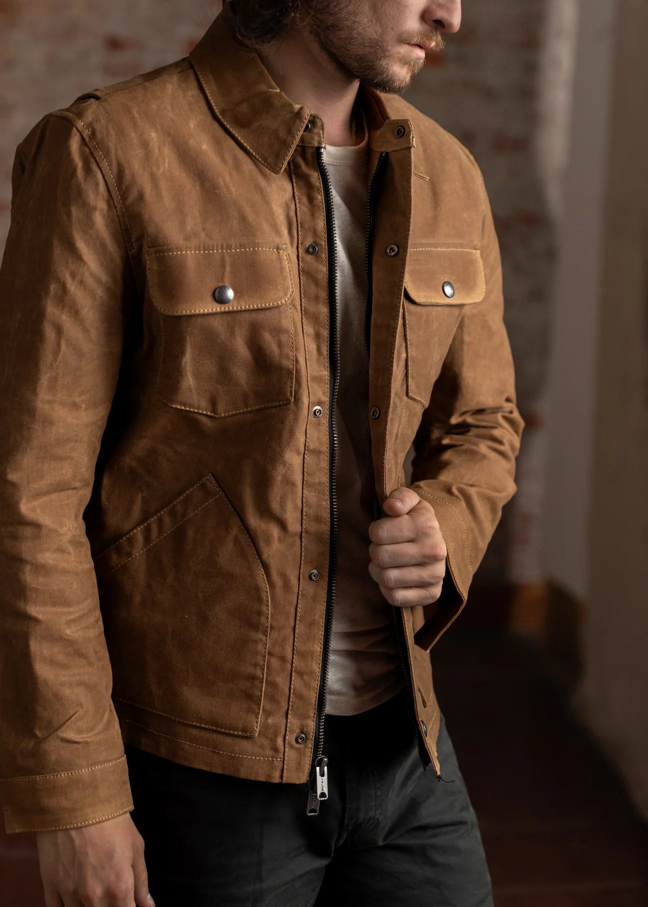 Man wearing a brown waxed canvas jacket